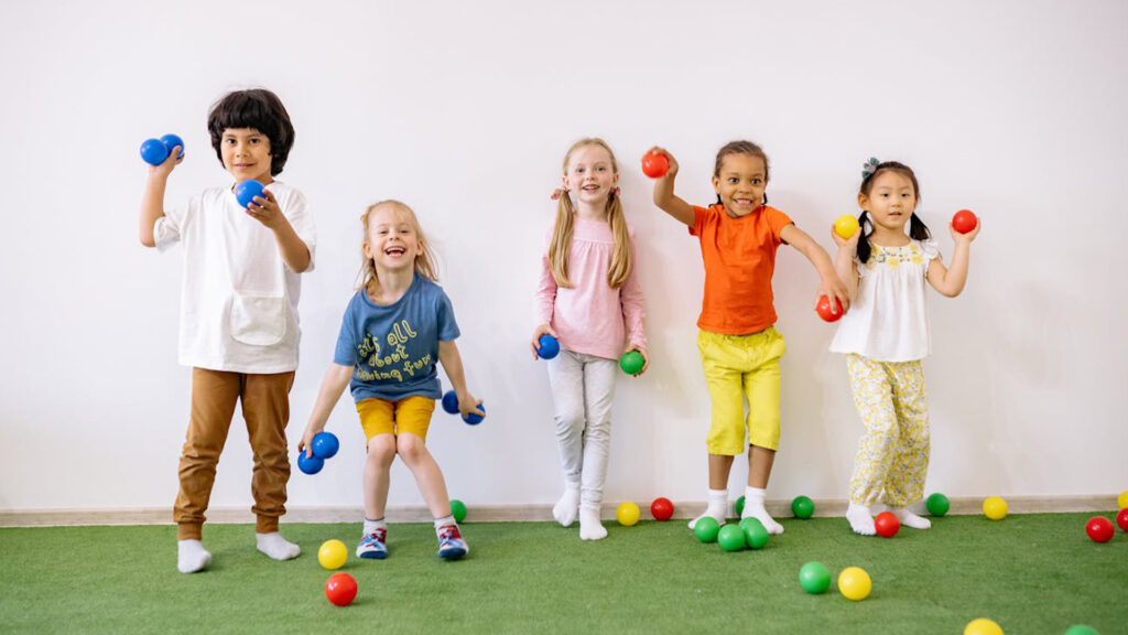 Toddlers Cheerfully playing with balls